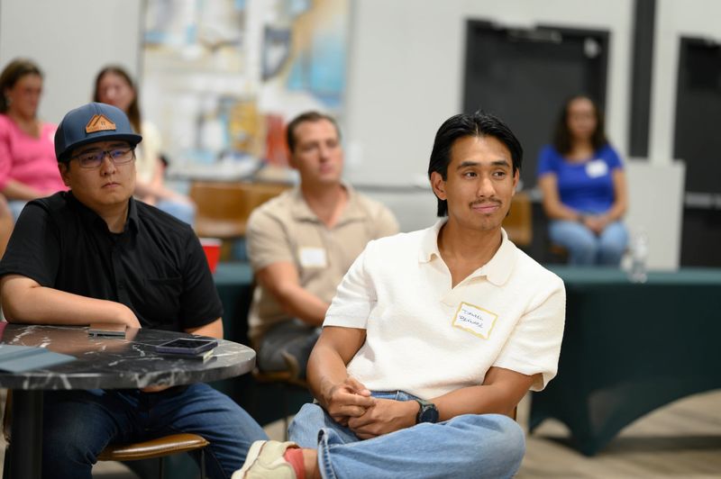 Guests with name tags listening to a talk