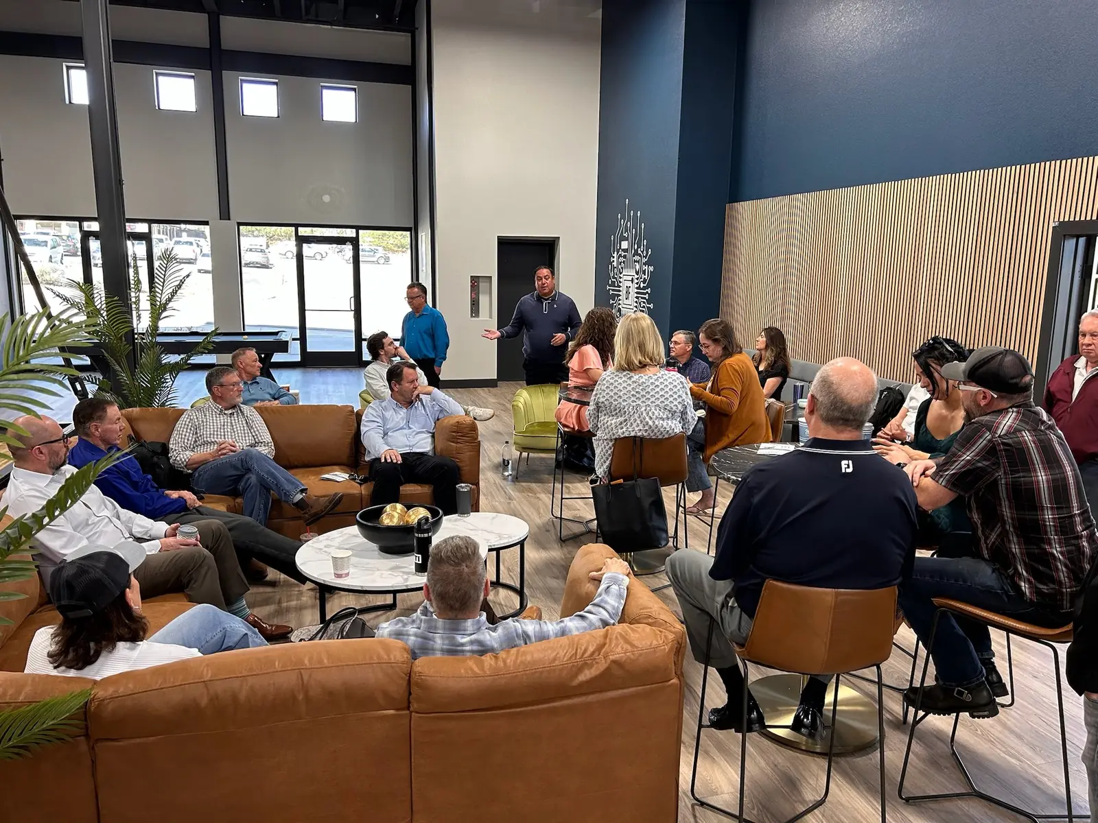 The event floor full, with guests seated at round tables across the room