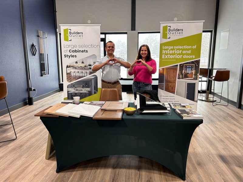 Builders Outlet at their table at one of our events, with cabinet and door samples on display