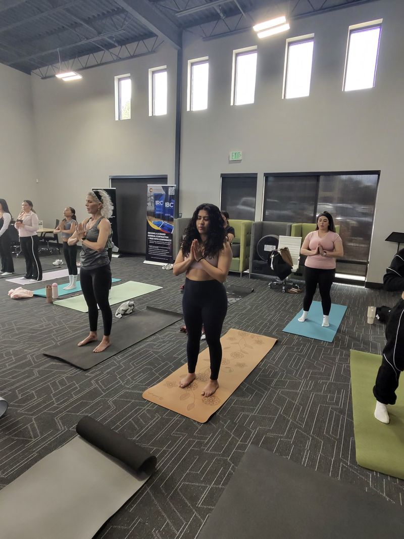 A yoga class on mats across the event floor