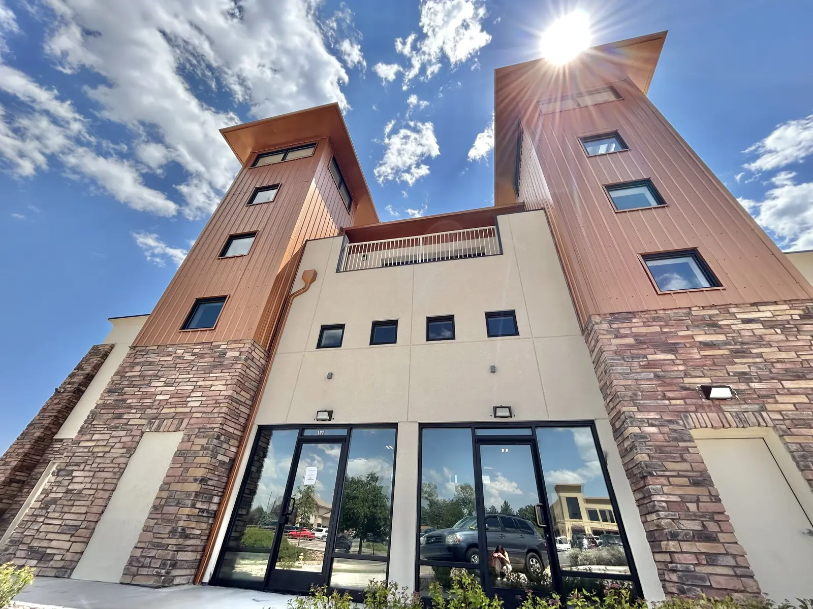 The Business Foundry towers in Lone Tree, lit by the afternoon sun