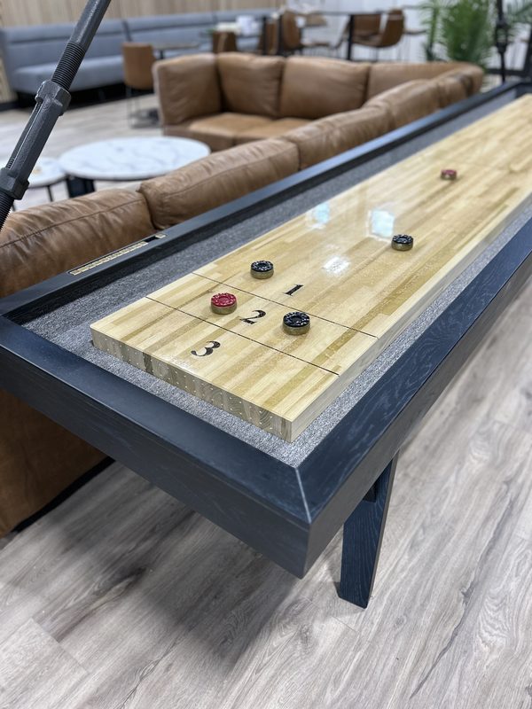 The shuffleboard table in the lounge, with leather seating behind it