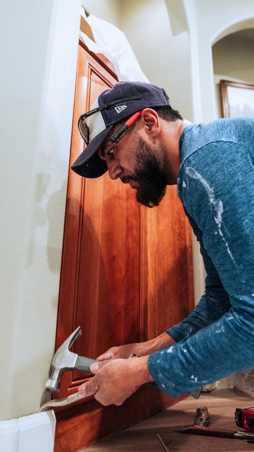 A contractor installing cabinet trim, shot during a client production